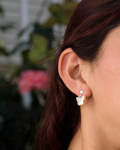 Modelo con aros mariposa colgante en plata 925, diseño elegante de Sylara